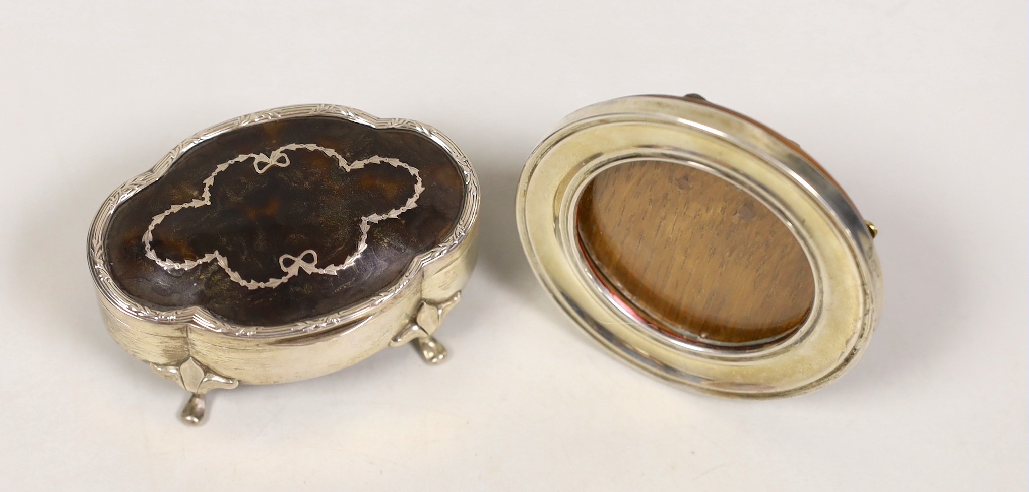 A small George V silver and piqué mounted trinket box, Chester, 1912, 79mm and a small circular silver mounted photograph frame.